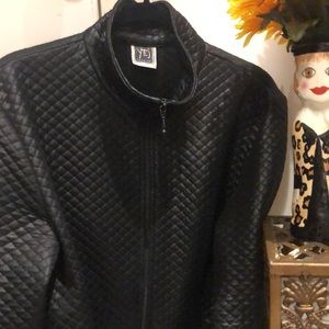 Great  lightweight quilted jacket. Has the “look of leather”—made of a fabric